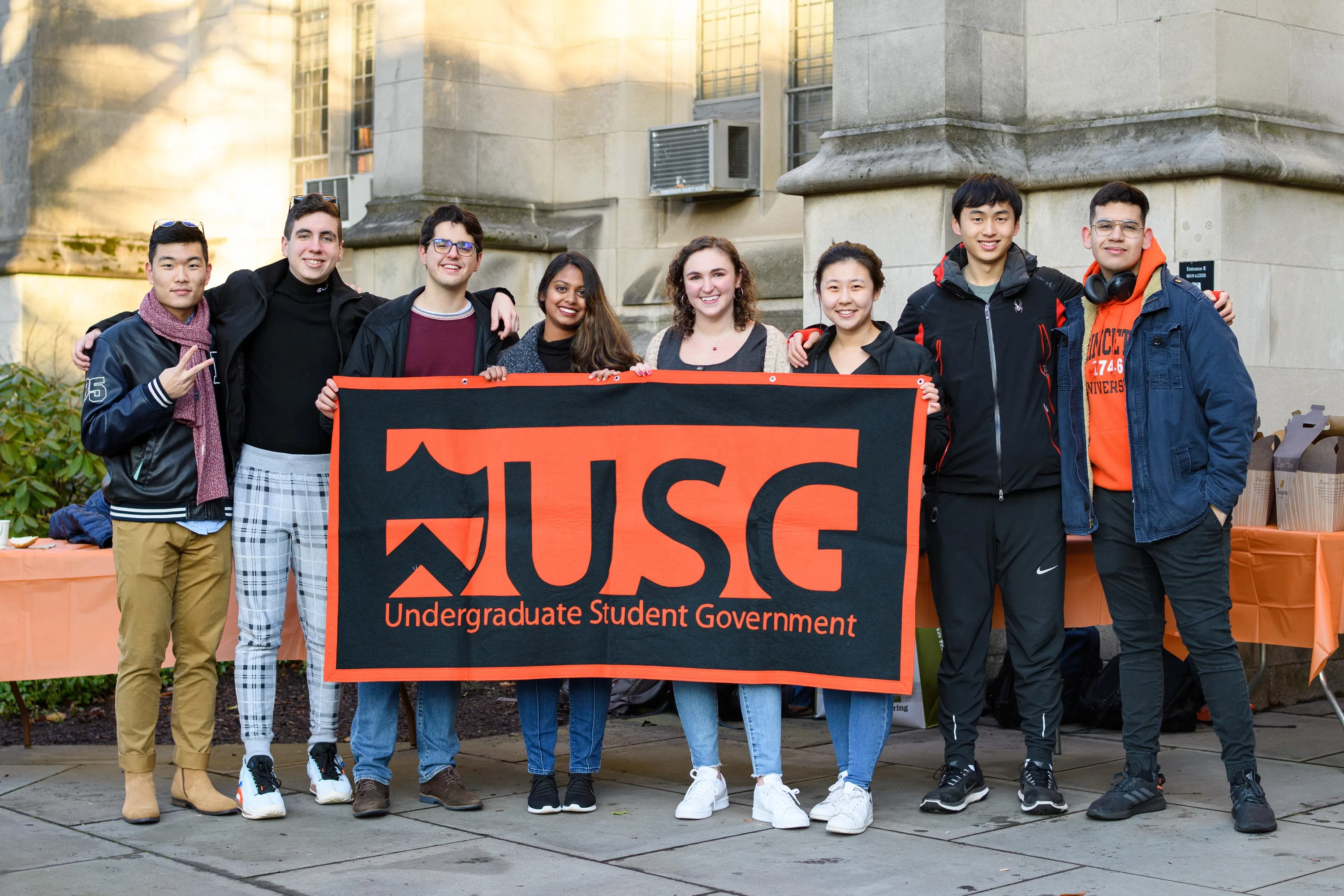 Members of Undergraduate Student Government behind a USG banner