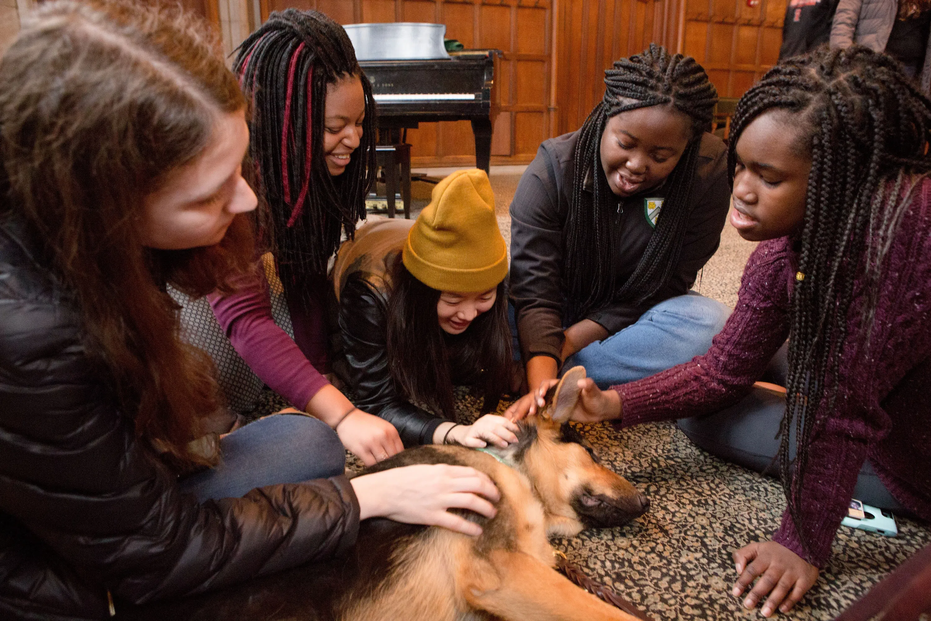 Students petting therapy dog. 