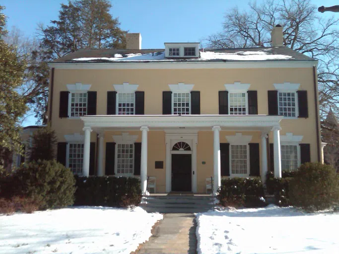 Yellow house with black shutters