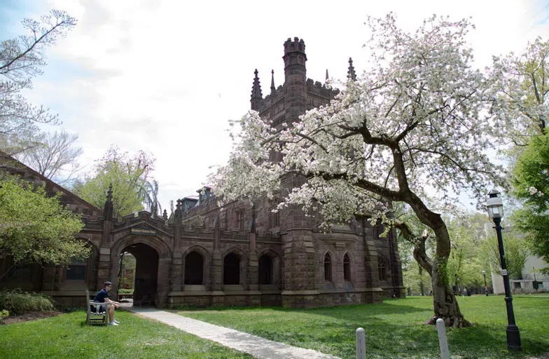 Exterior of Murray-Dodge Hall in spring with flowers blooming