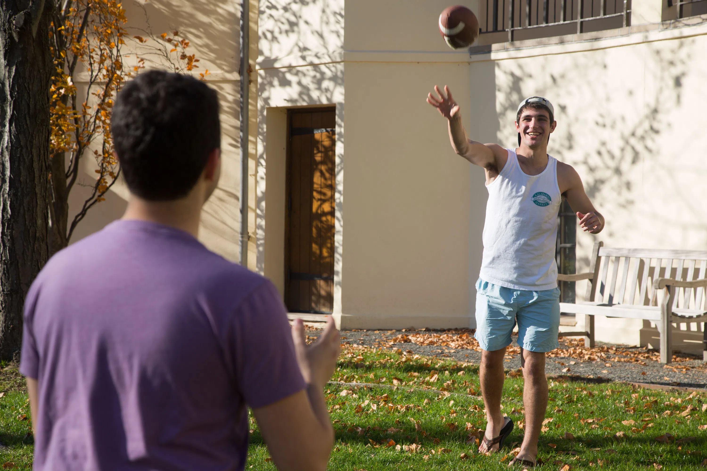 Students throwing football outside the CJL 