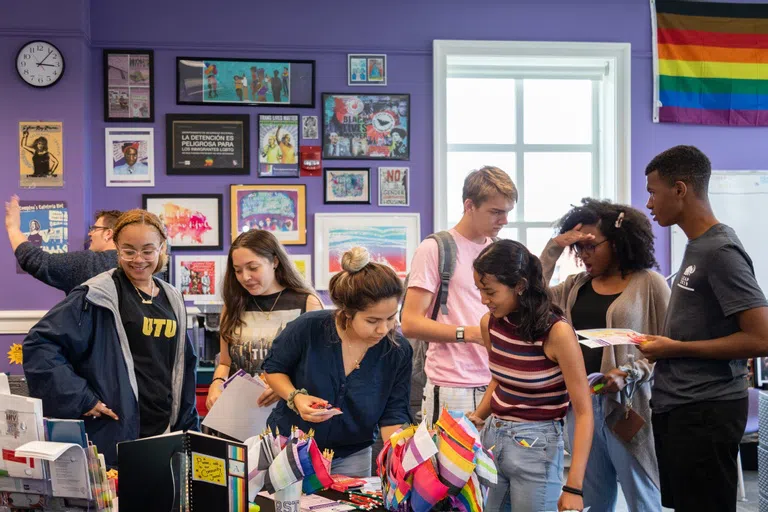 Group of students standing in Queer Resource Center