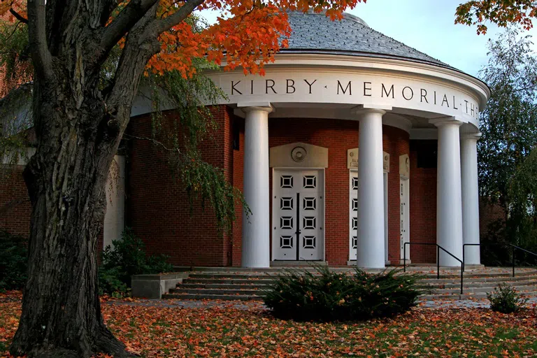 Exterior shot of Kirby Memorial Theater in fall with orange leaves in front