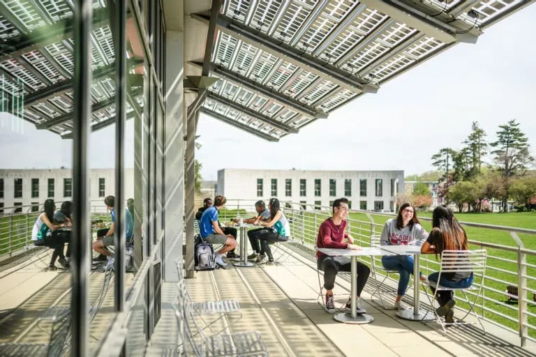 Students sitting on the University Commons balcony