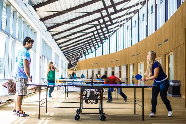 Students playing ping pong in The Commons