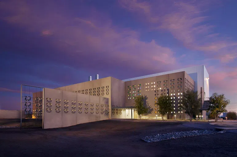 Exterior of concrete building at dusk. 