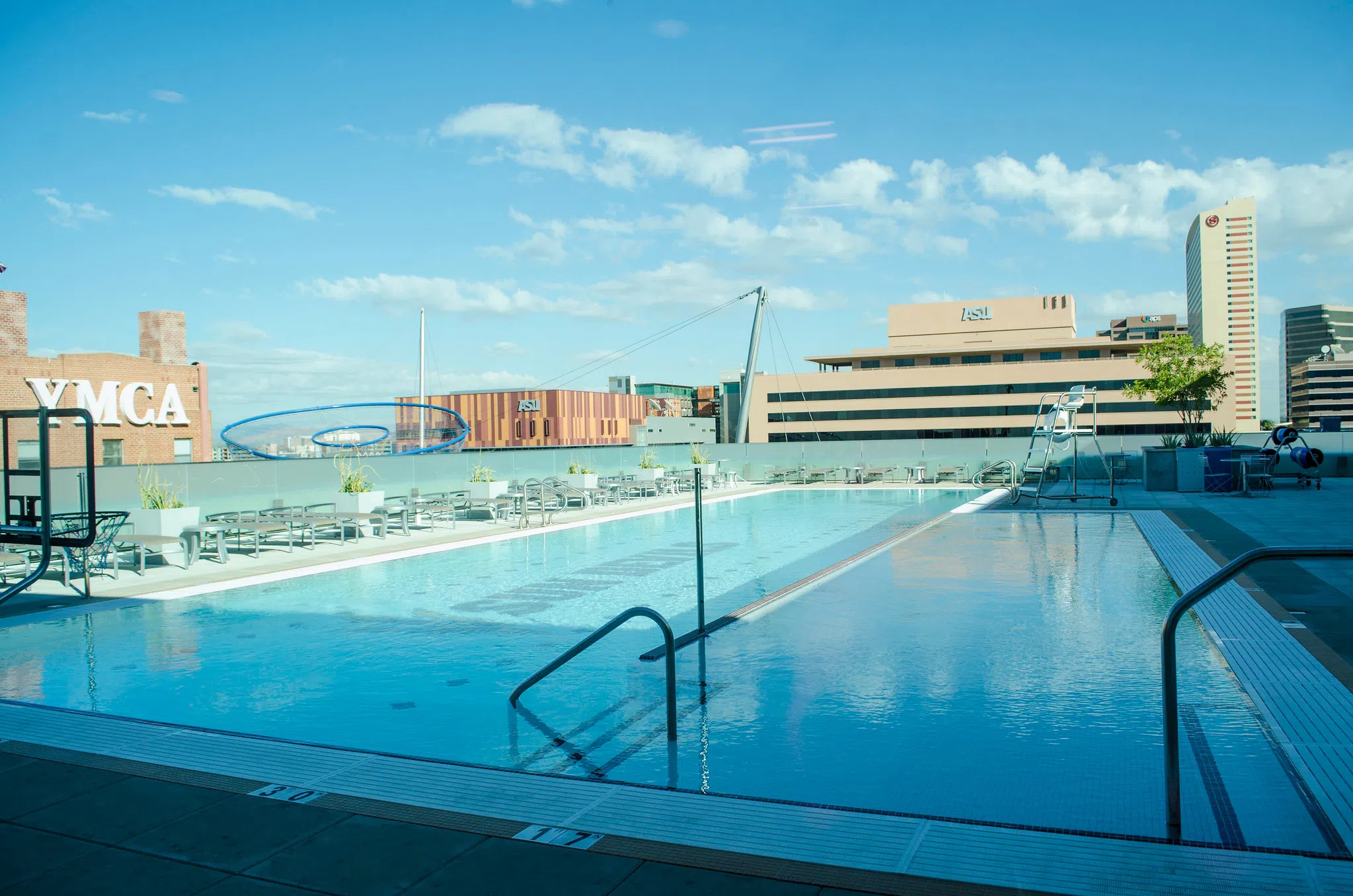 Rooftop pool and view of campus beyond it. 