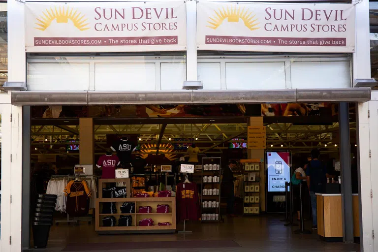 View inside open door to campus store shows shirts and sweatshirts for sale.