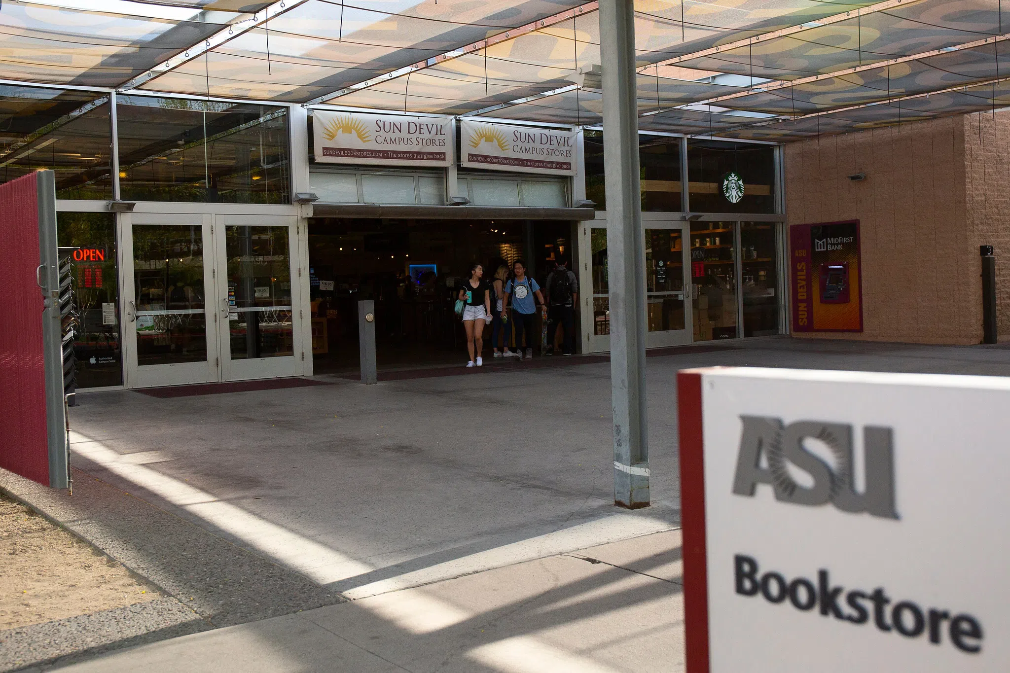 Covered patio and ASU Bookstore sign in front of entrance to Sun Devil Campus Store. 