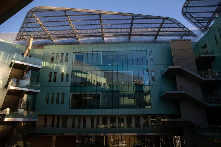 A large four-story wall of windows in the courtyard of a building.