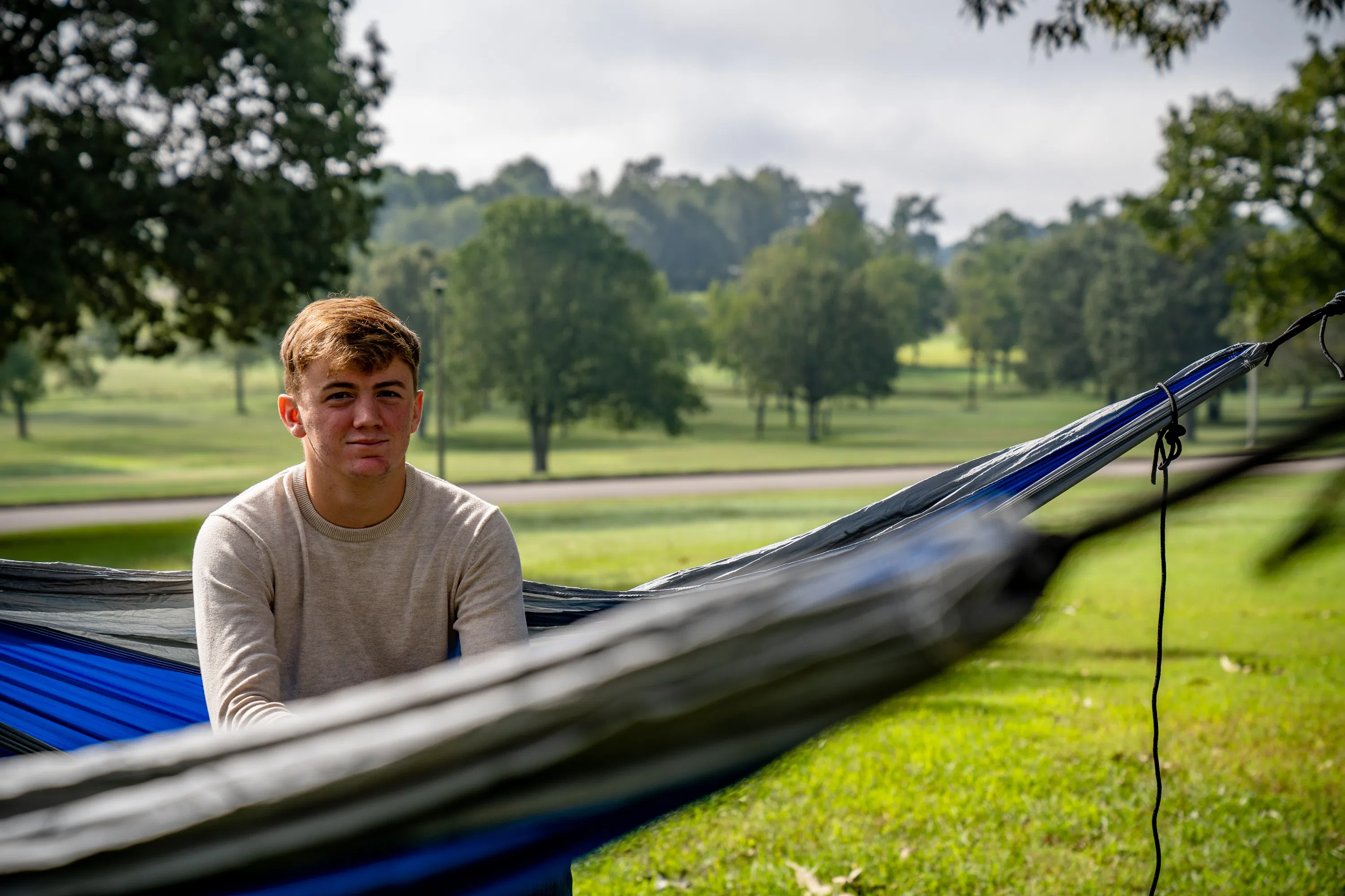 Student sits in hammock