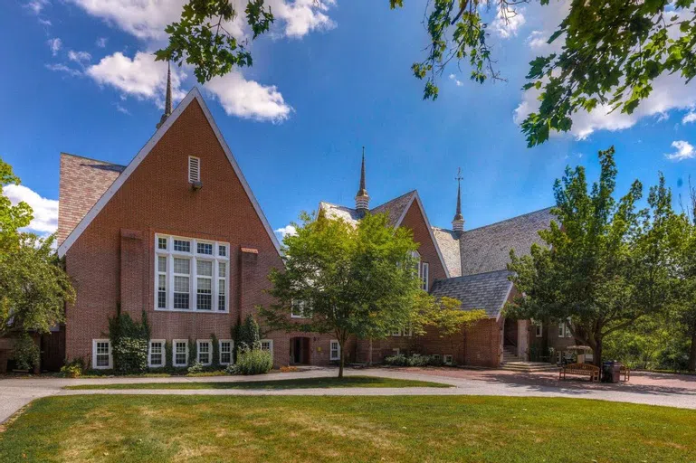 Exterior of Chase Hall shows a red brick building with several large spires