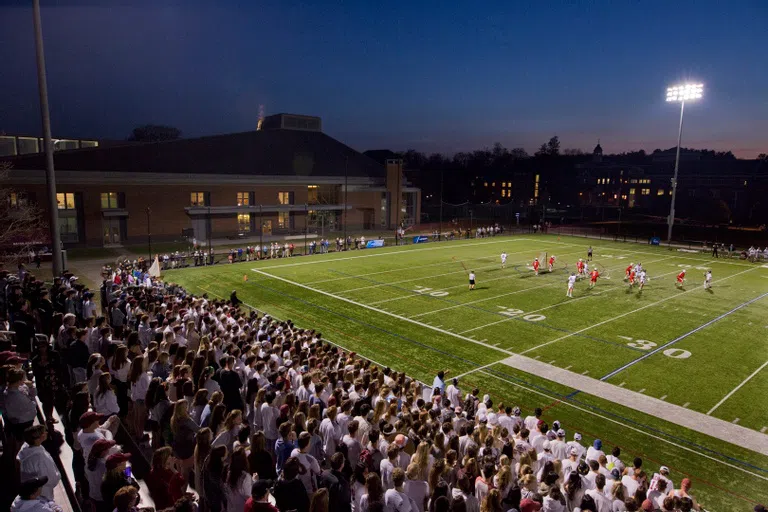 The Bates Lacrosse team plays at night for a large crowd