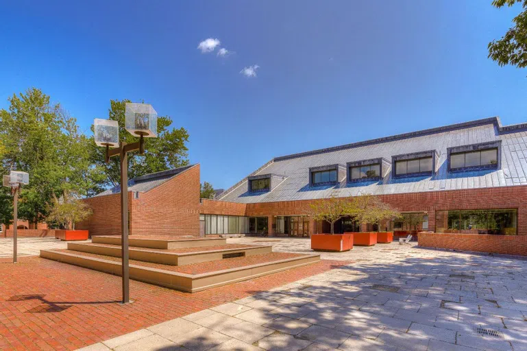 Exterior of Ladd Library features brick courtyard and two story brick building.