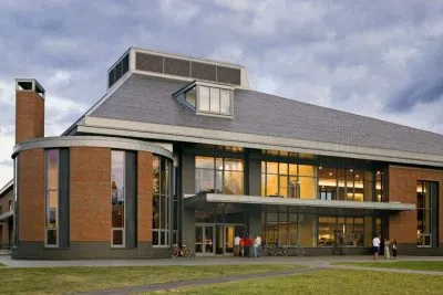 Exterior view of Commons shows a three floor brick building with large glass cutouts