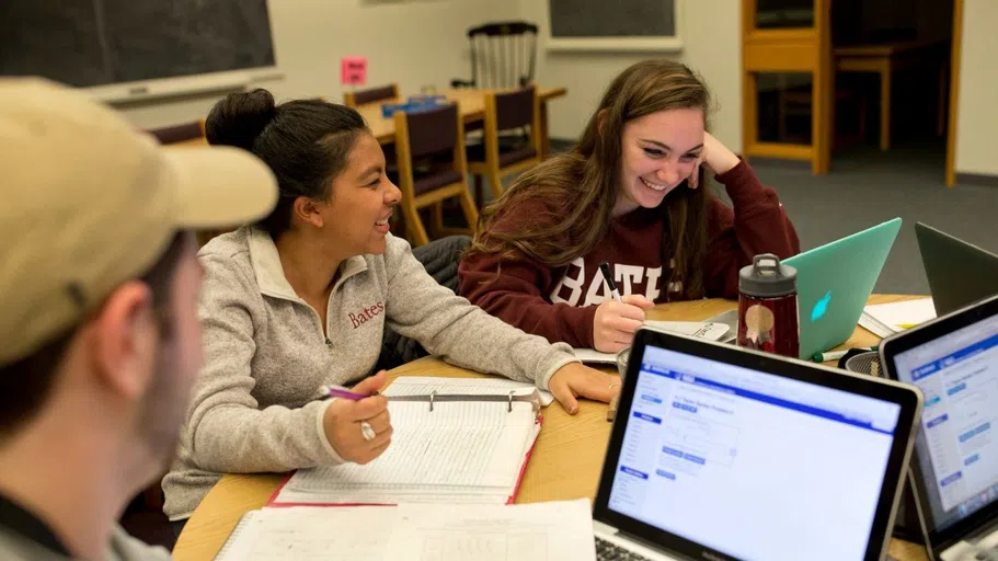 Students gather at a table to study together.