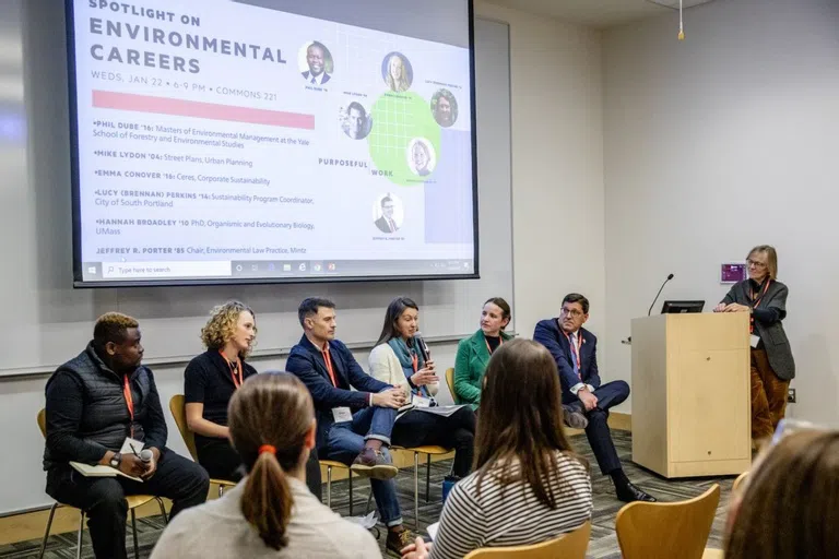 Five panelists are assembled in front of a presentation entitled 'Spotlight on Environmental Careers'