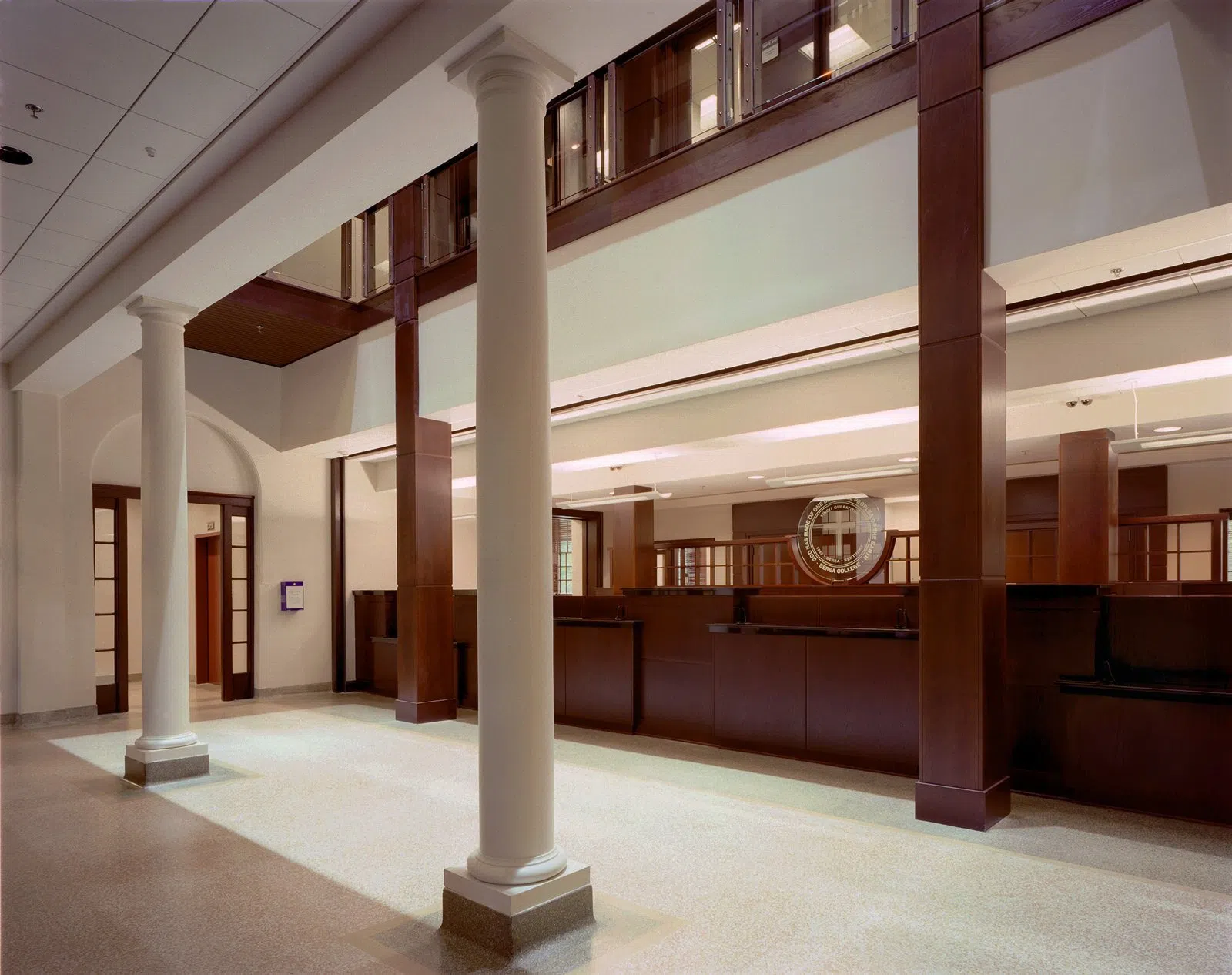 Interior photo of large lobby with dark wood and lots of natural lighting