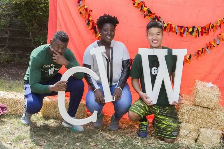 Students holding "CIW" signs