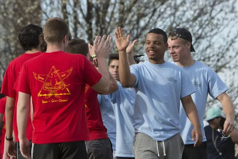 Students high-five one another while participating in DormWars.