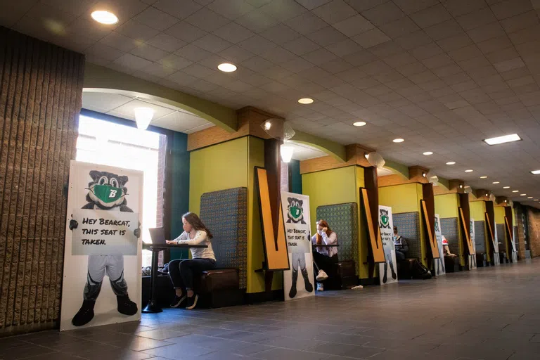 Tables with booths line the wall in this location of the library