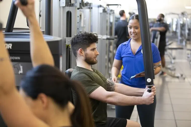 Students using weight machines