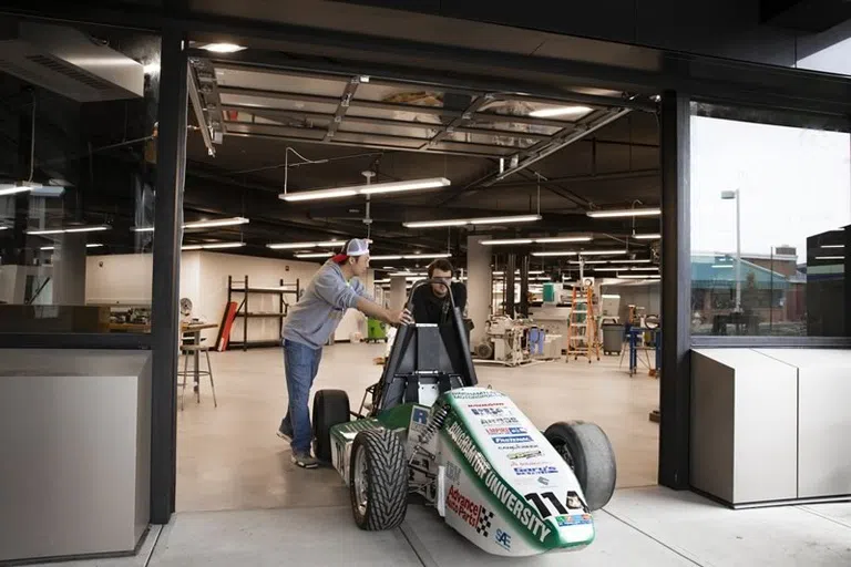 Students creating a race car in the engineering lab.