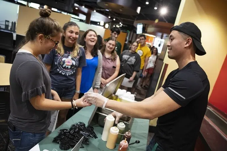 Students wait in line for their meal