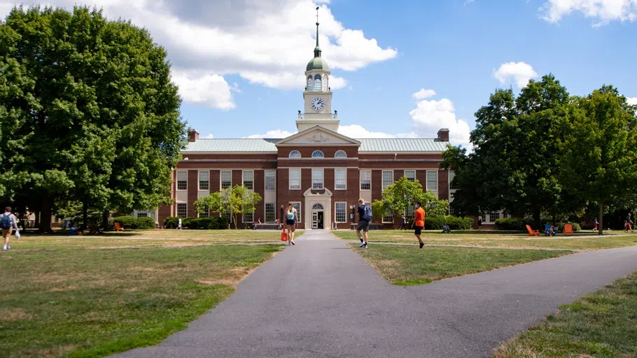 3 students walk on the quad in front of Bertrand Library