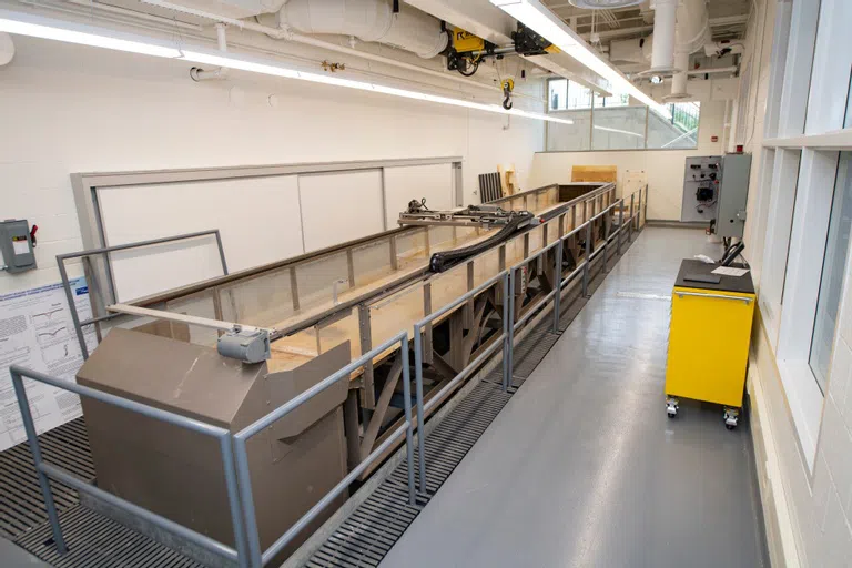 a large piece of machinery taking up a long classroom lab