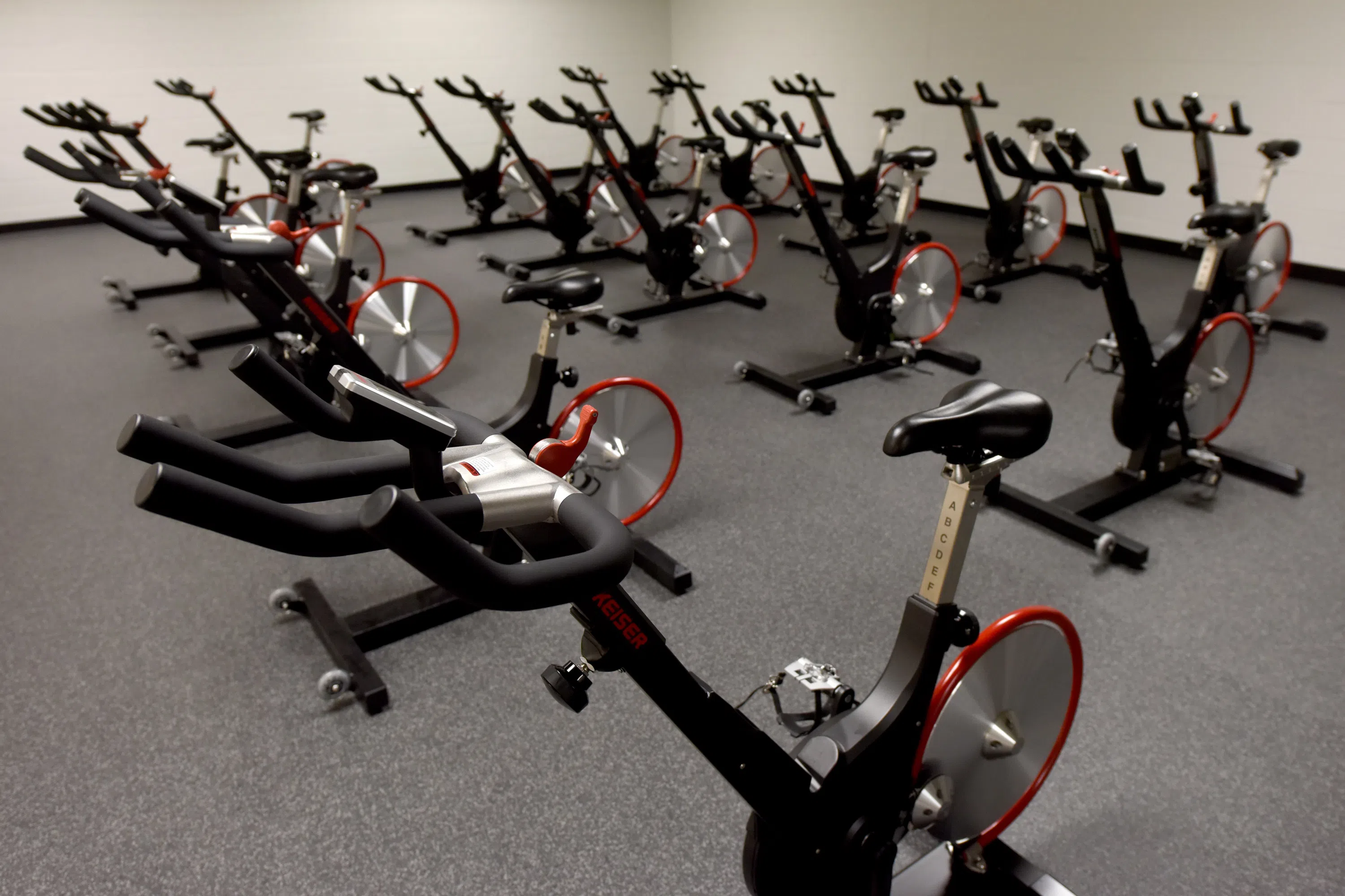 a group of exercise bikes in a workout room