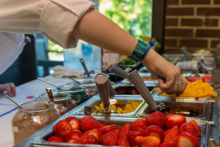 a close-up of fruit in a buffet at a cafeteria station