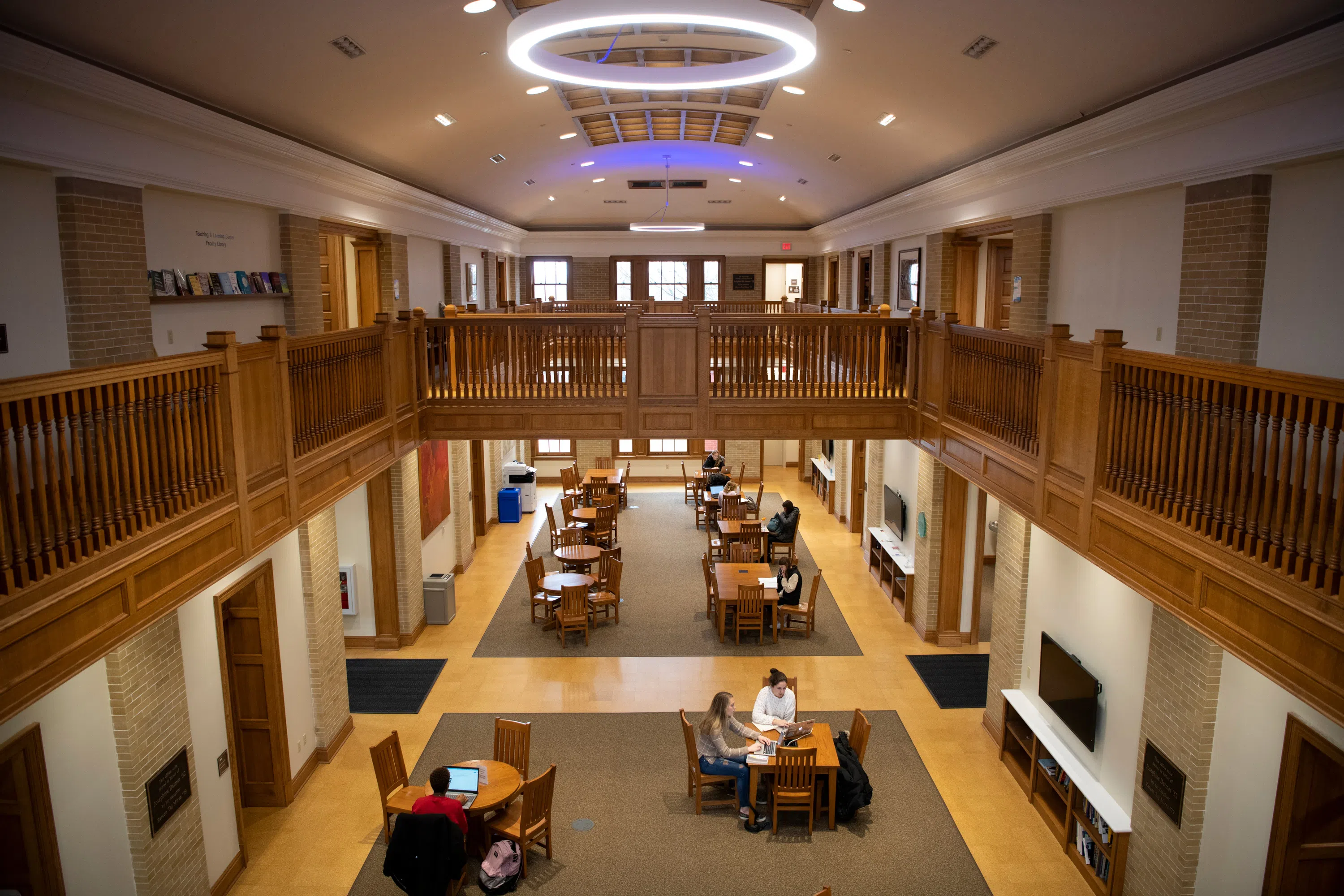 students study at tables in a large room