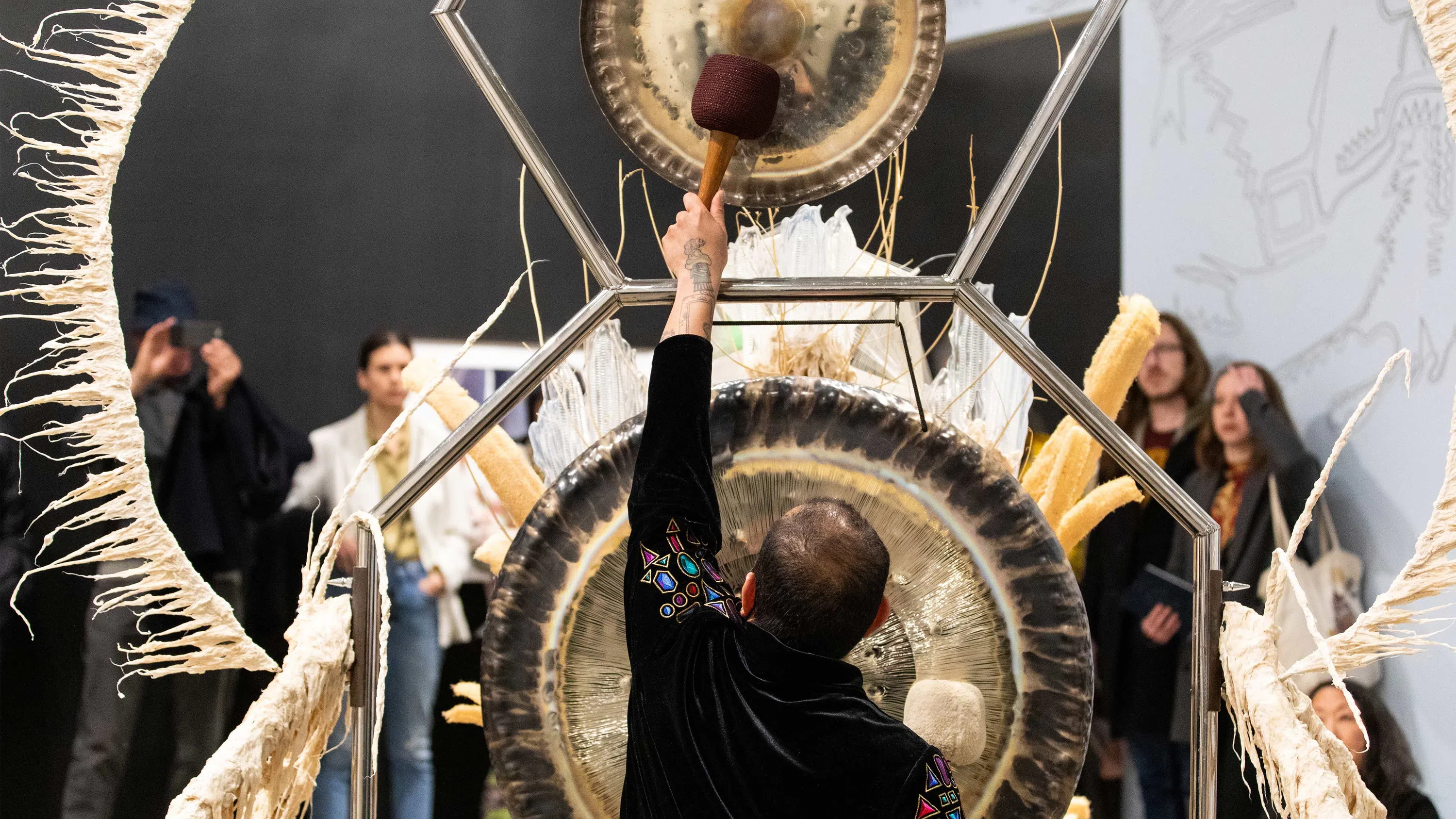  A person bangs on a large percussion instrument. 