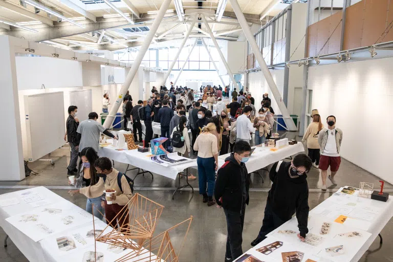 Students in the Nave looking at architecture models on tables