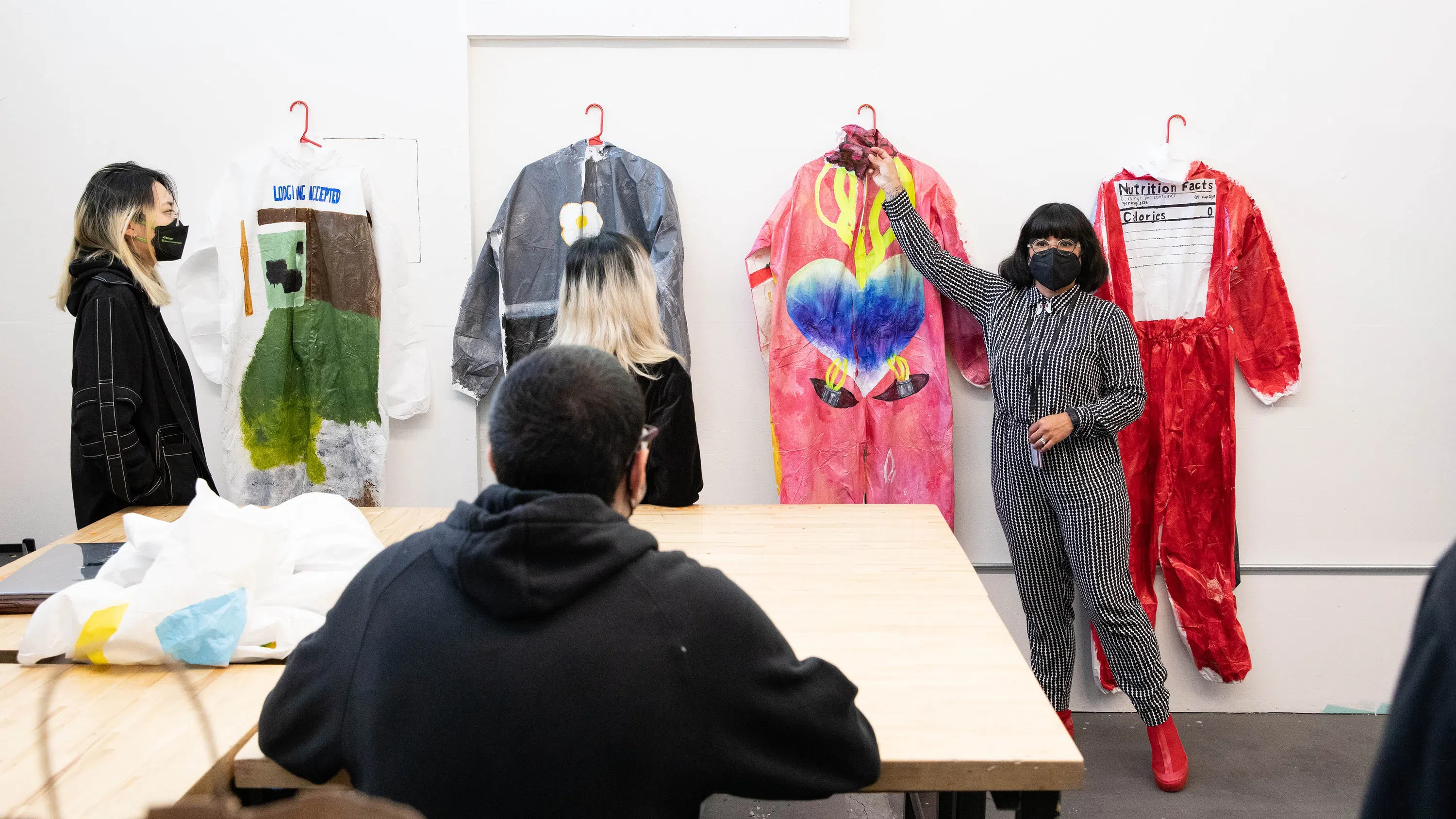Two students present their colorful, wearable jumpsuits. 