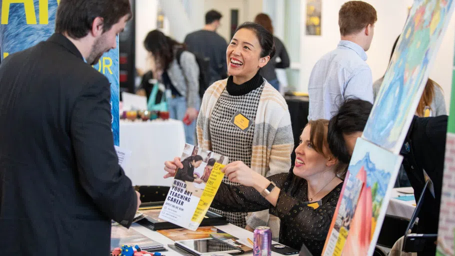 A student talks with two employers at the 2019 Career Expo.