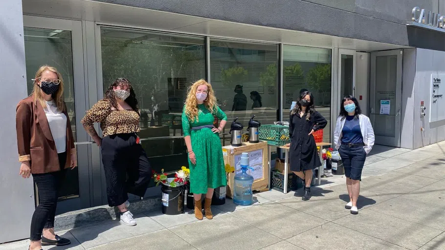 Four students stand outside the Wattis Institute.