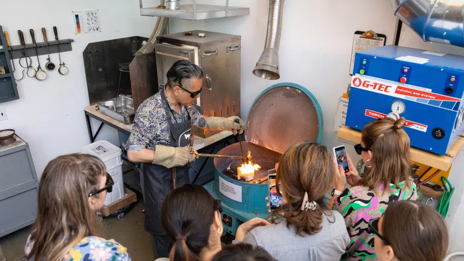 Chair Curtis Arima demonstrates wax casting in a kiln.