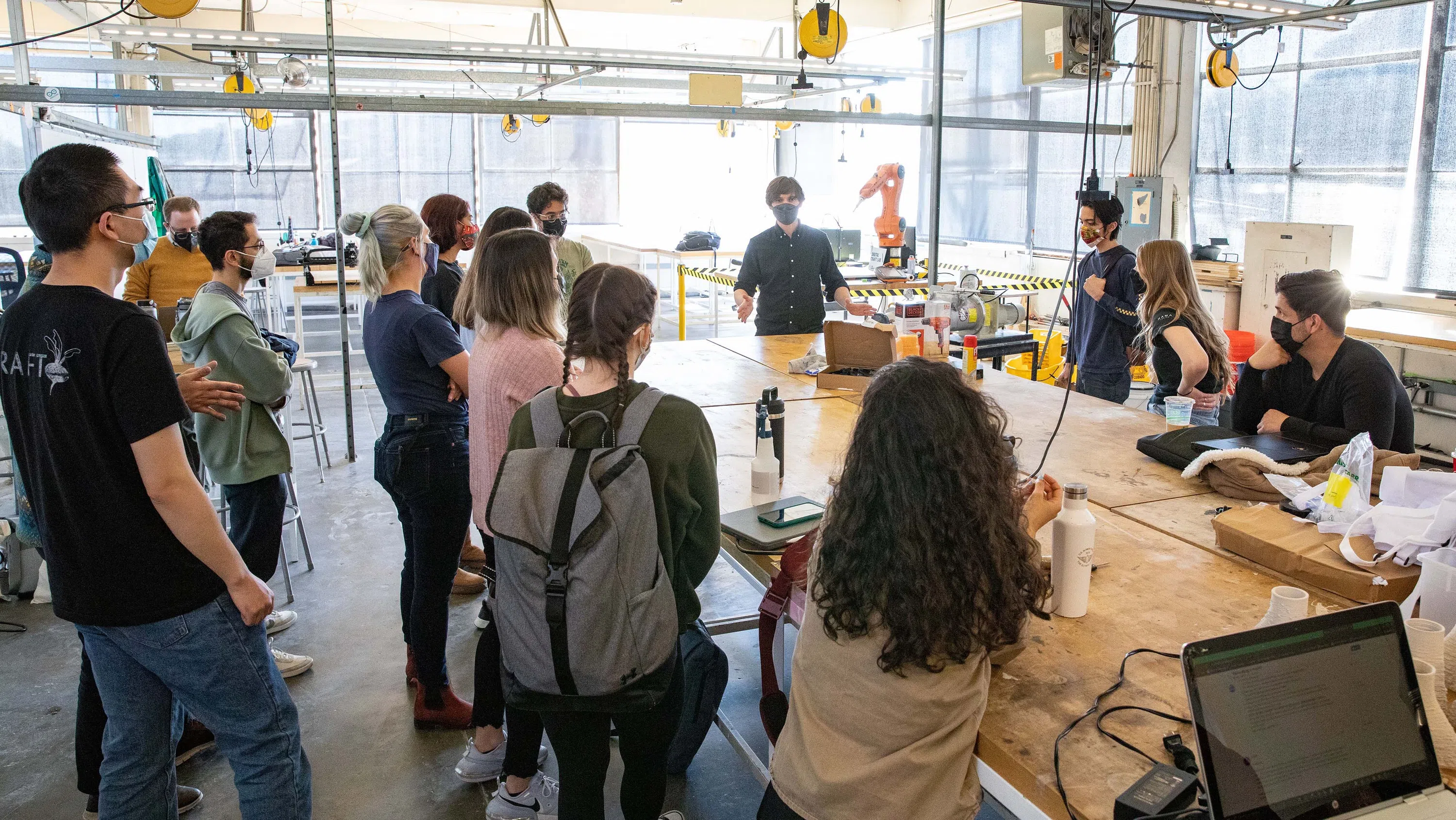 A wide shot of students learning how to use a tabletop 3D printer in the Digital Craft Lab.