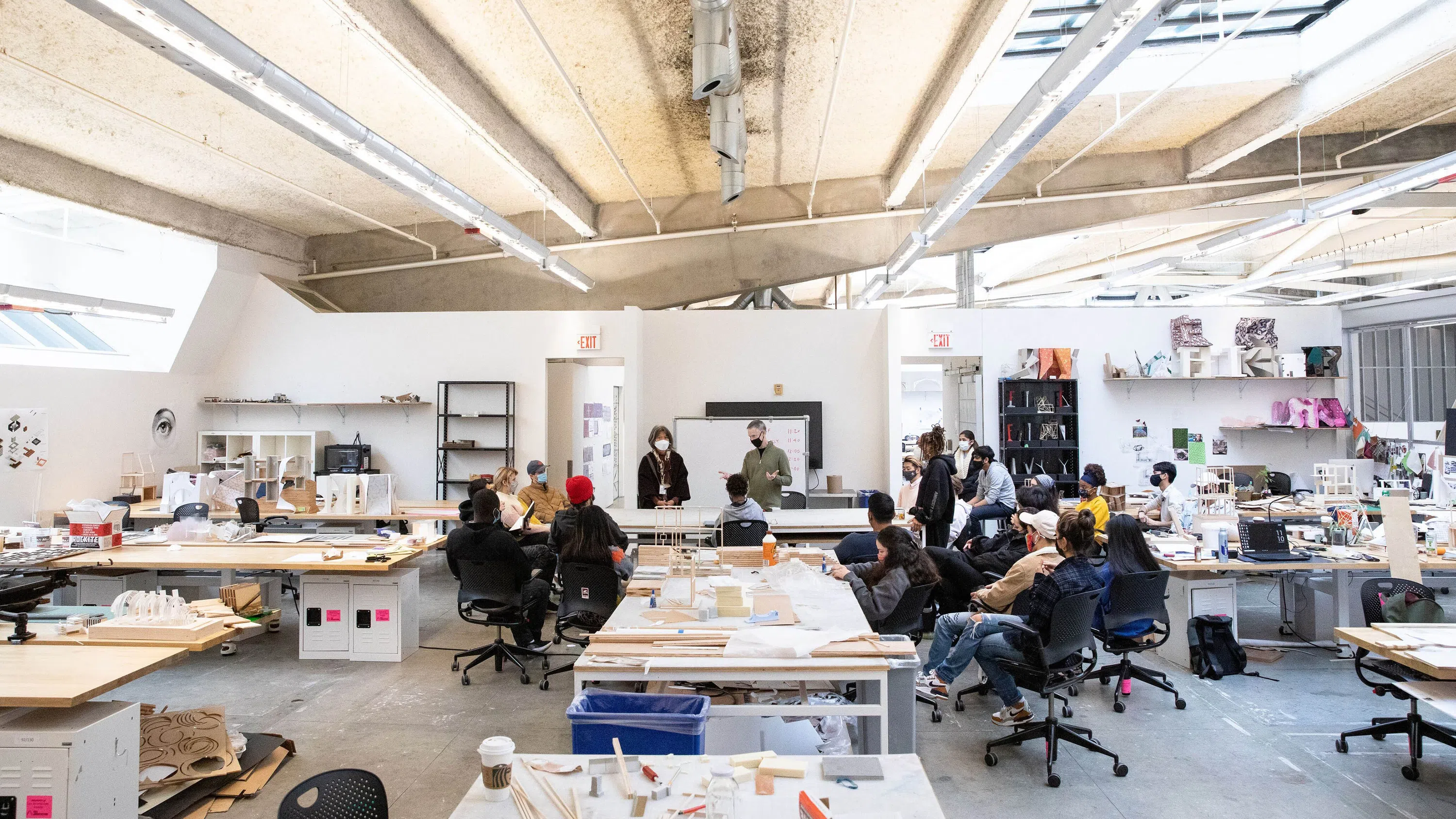Wide shot of students and faculty in the Architecture studio. 