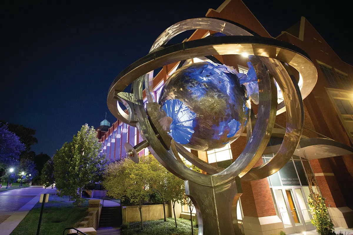 Large metal globe statue that stands outside of the Harper Center