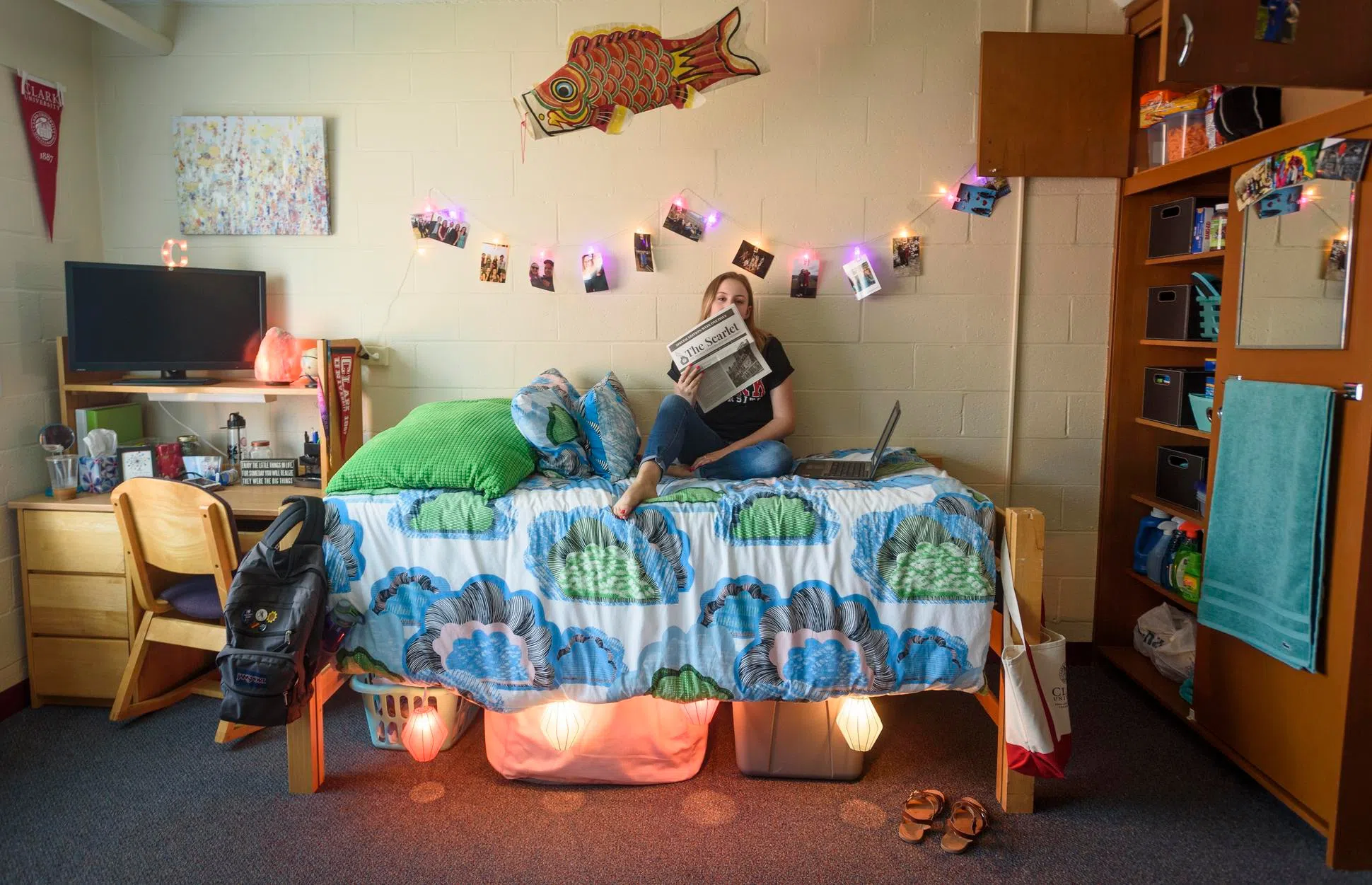student reading paper in dorm room