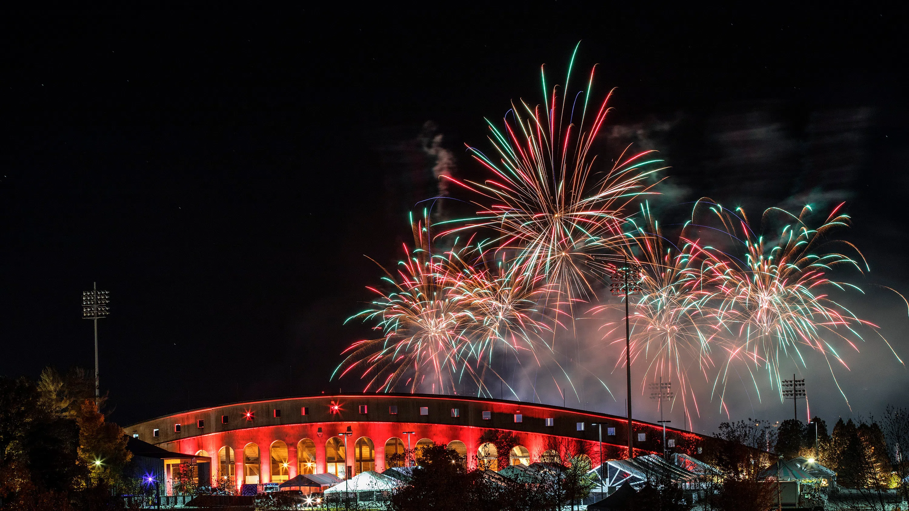 A fireworks and laser light show illuminate the sky above Schoellkopf Field during the homecoming celebration.