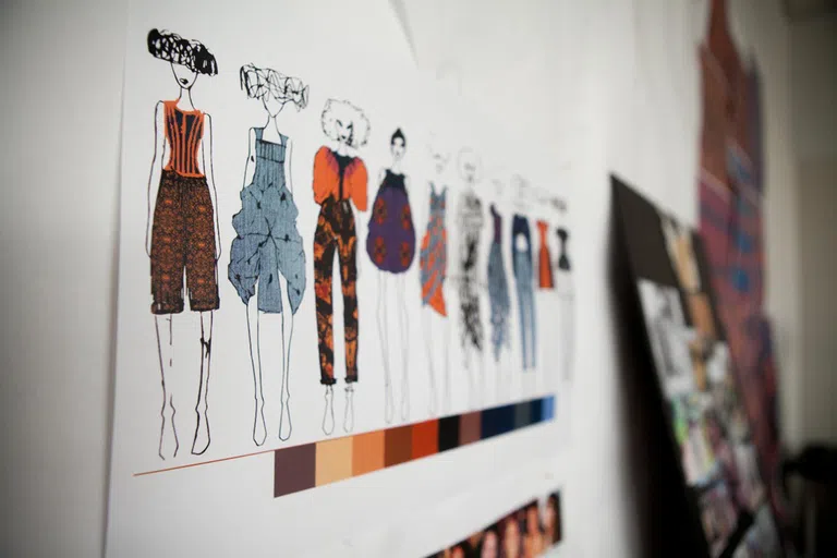 Apparel sketches adorn the walls of the fashion design studios in the Human Ecology Building. The sketch shows a row of female subjects, each wearing a different outfit.