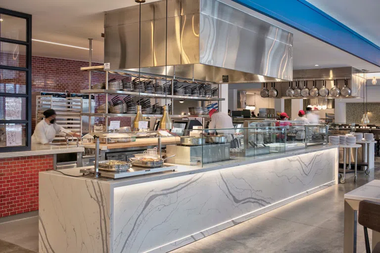 Cornell Dining staff prepare food in a serving area at Toni Morrison Hall.