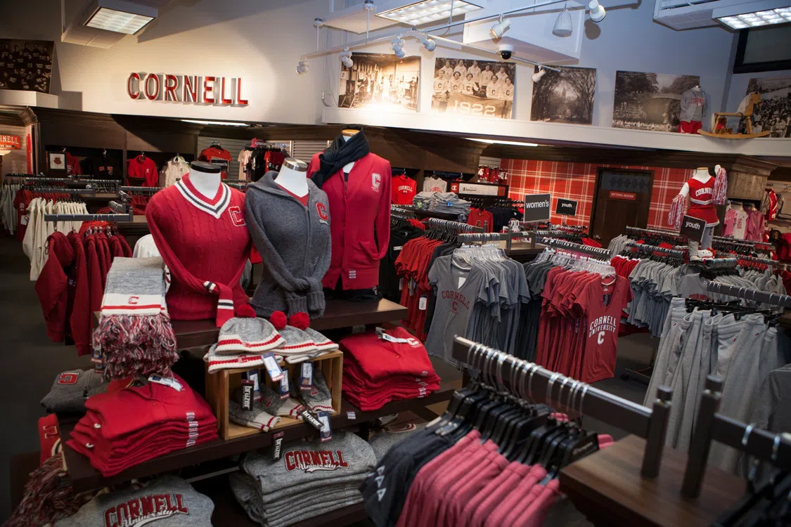 Shelves, racks and a full display of Cornell-brand clothing and merchandise.