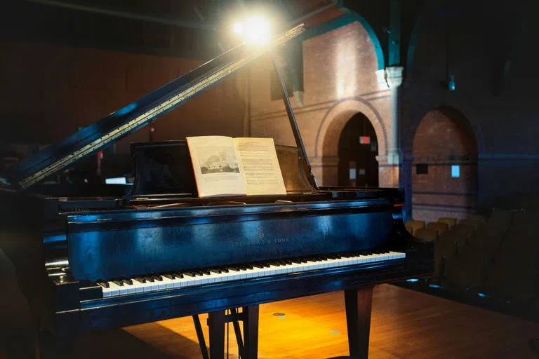 A Steinway grand piano, part of the Department of Music’s collection of 18th- and 19th century pianos at Barnes Hall, holds the sheet music to Cornell’s “Alma Mater.”