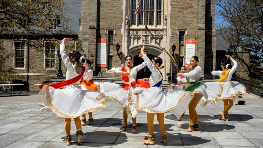 Members of Cornell Nazaqat, an Indian classical dance team, perform a dance called kathak on Ho Plaza outside Willard Straight Hall.