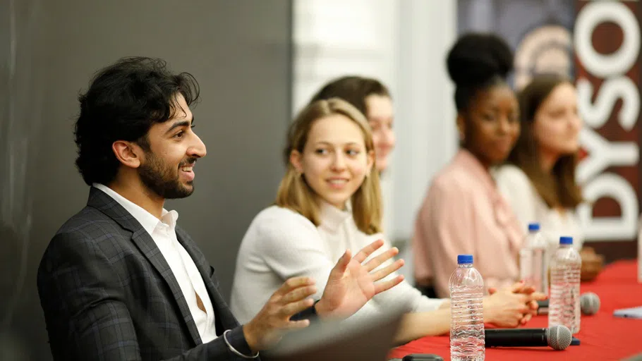 A student presents as part of a panel discussion at the Dyson School.